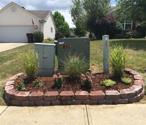 big green electrical box in yard|landscape around electrical transformer boxes.